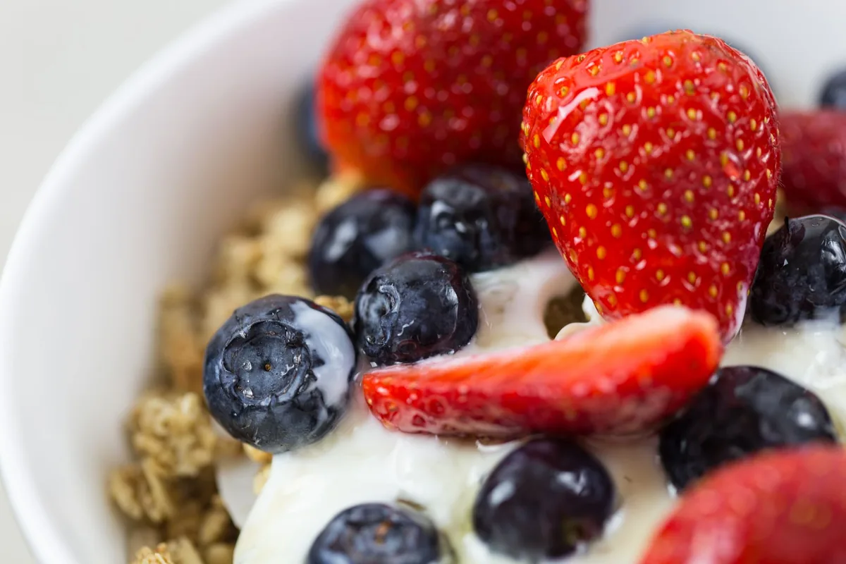 A bowl of plain yogurt with berries