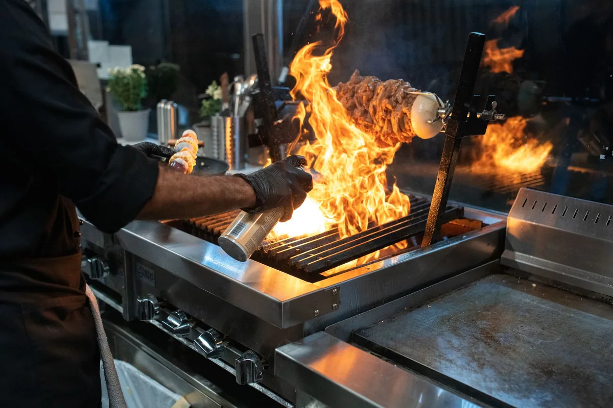 A chef cooking over high heat