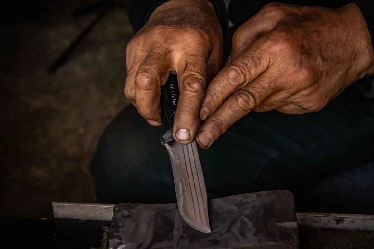 A chef knife on a whetstone