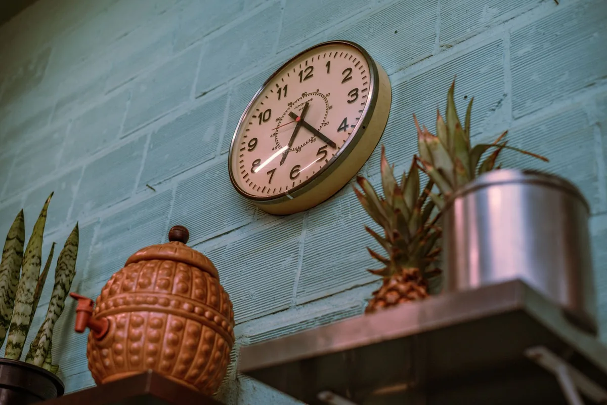 A clock on a kitchen wall
