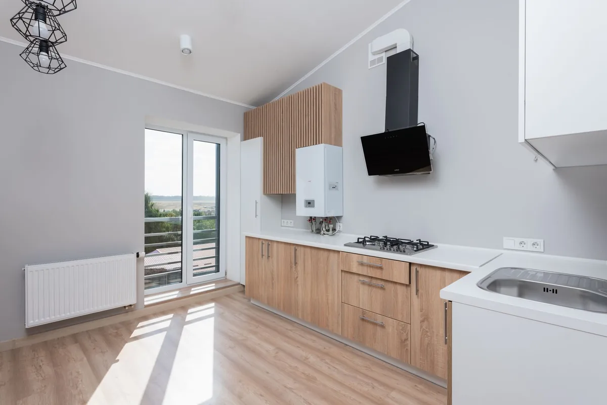 A fitted kitchen in daylight