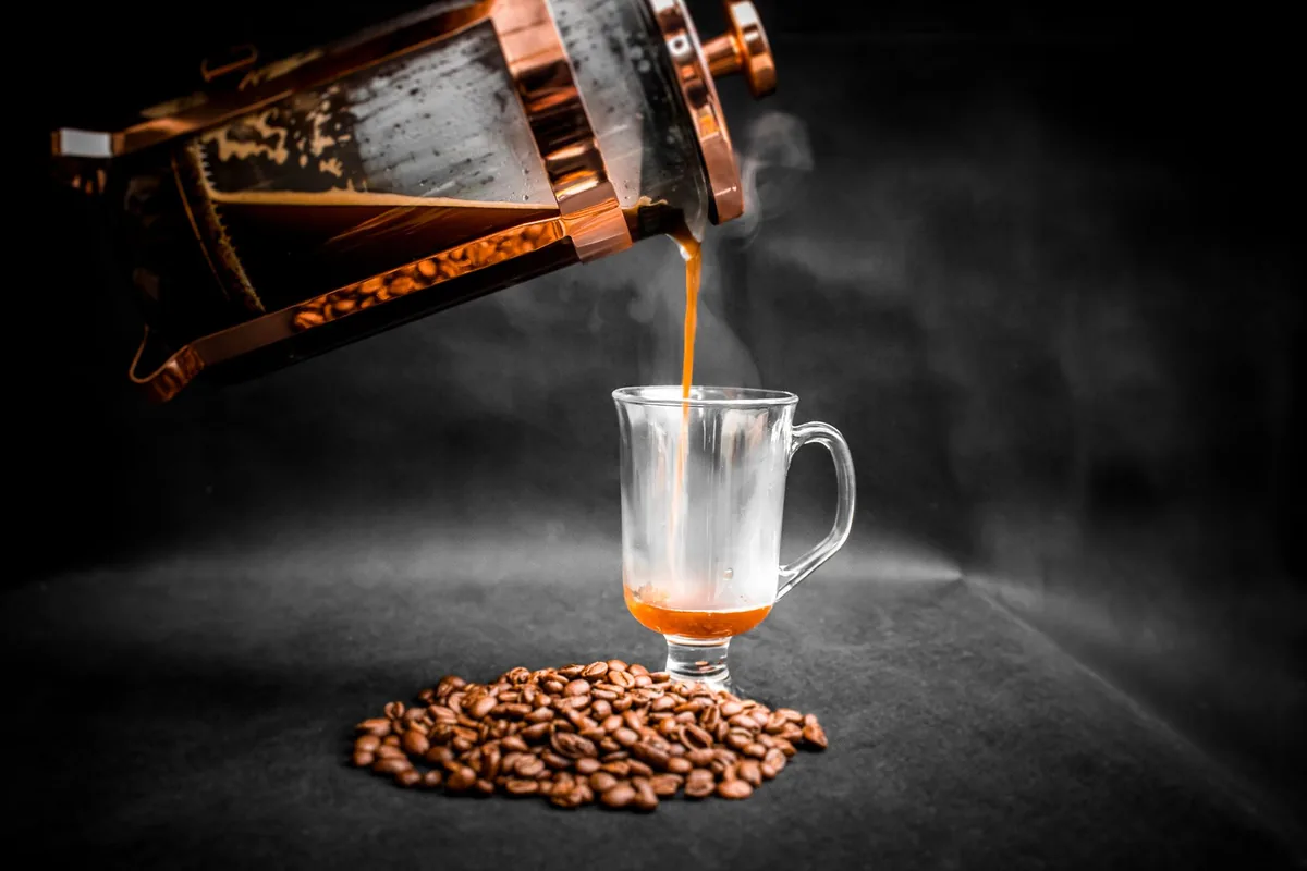 A French press full of brewed coffee