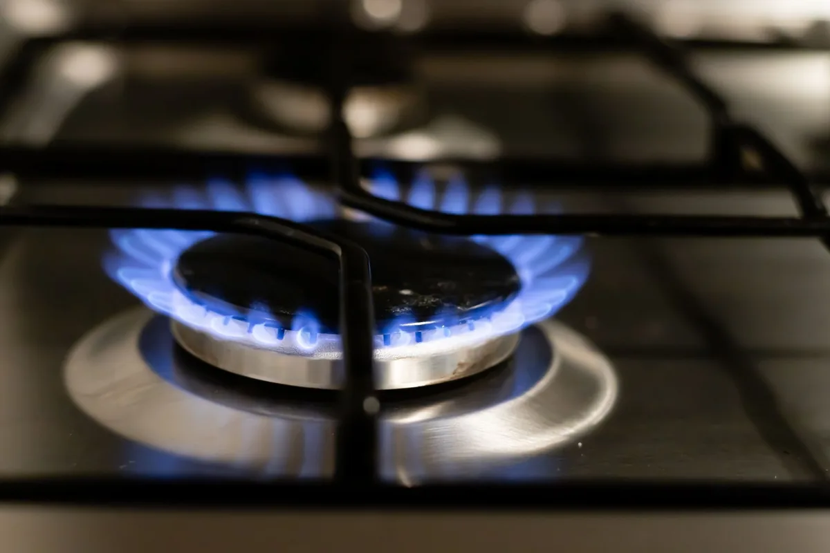 A gas burner under a pan