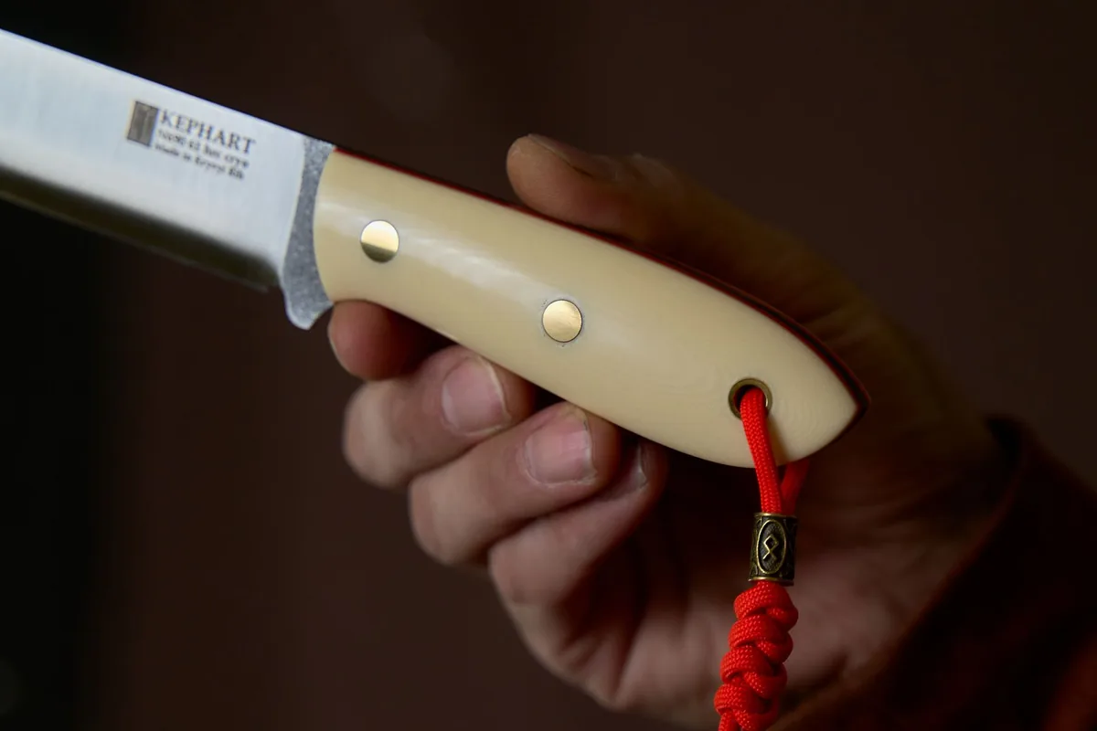 A hand gripping a handle