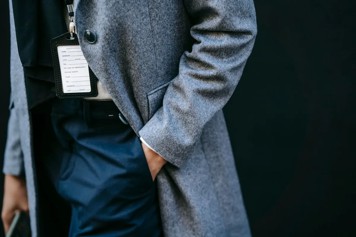 A hand in a coat pocket