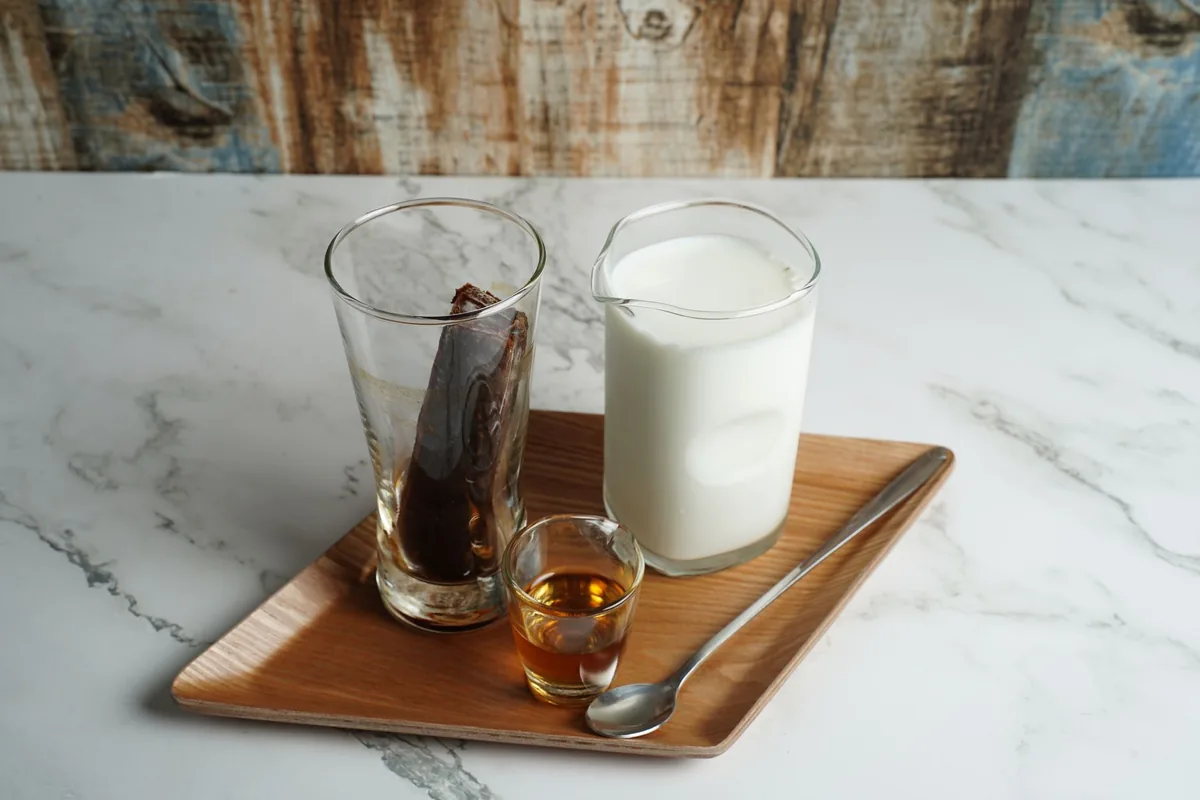 A jug of iced coffee with milk