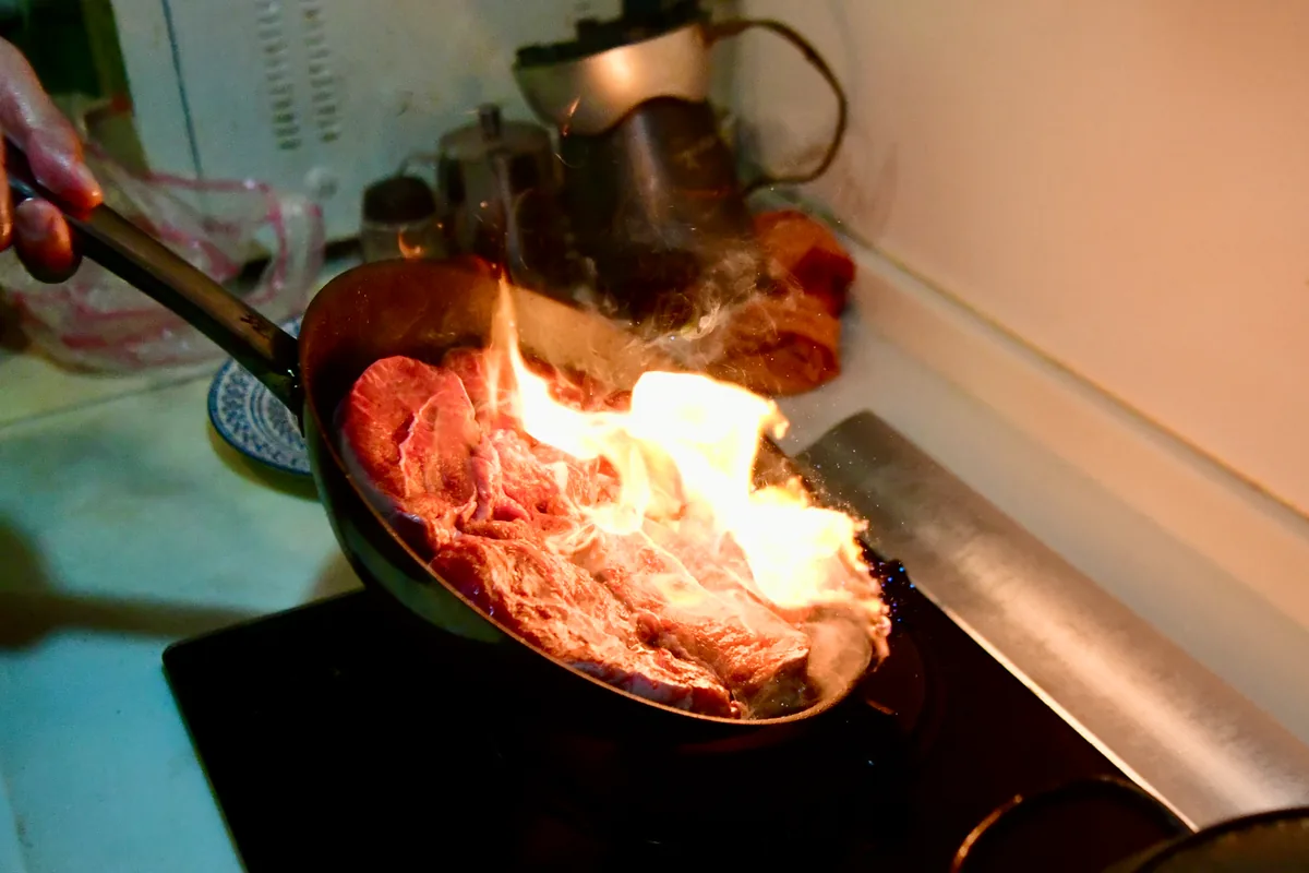 A pan searing on a hob