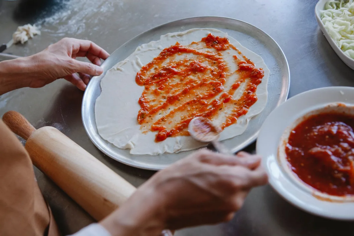 A pizza base before baking