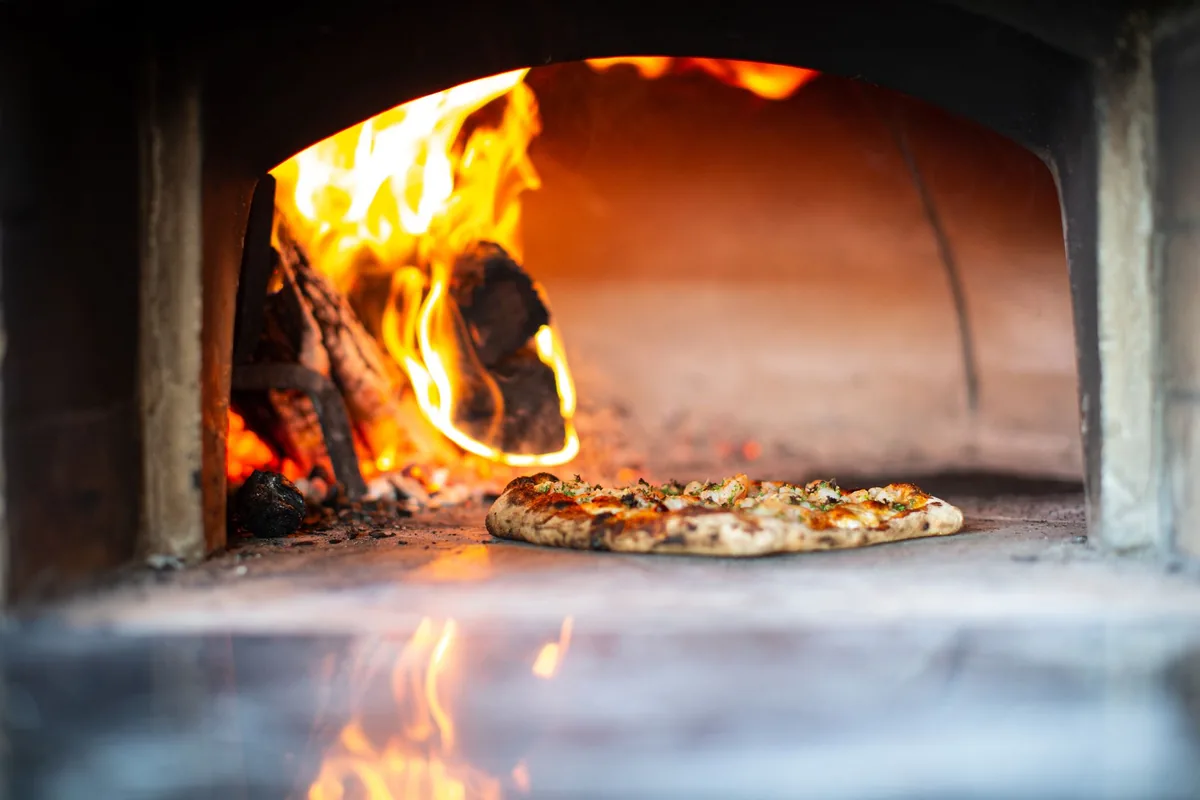 A pizza going into an oven