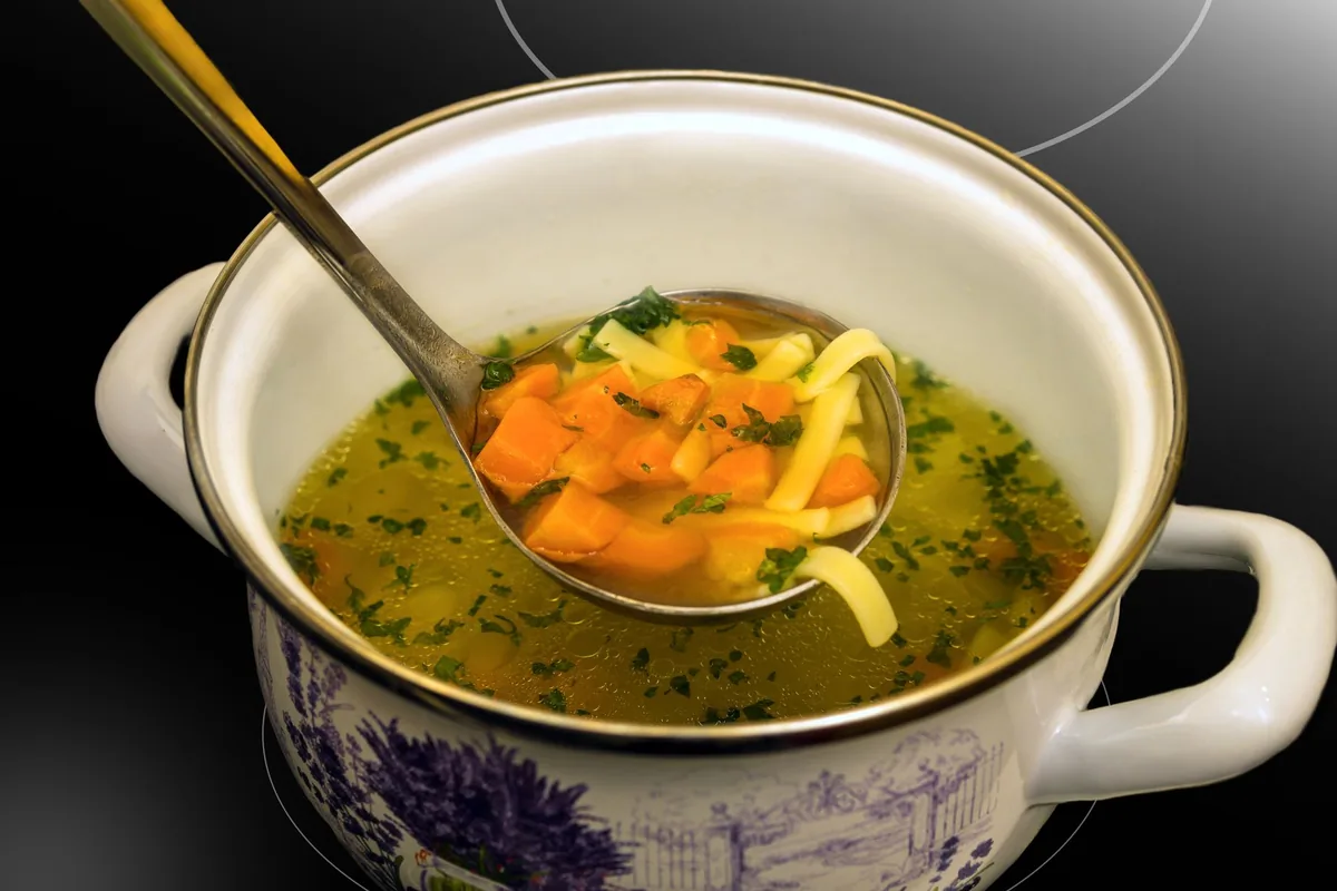 A pot of chicken stock with bones