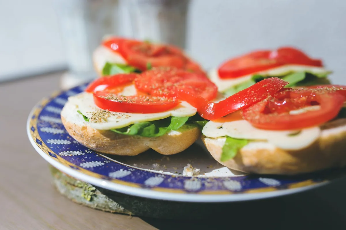 A pressed sandwich with tomato and basil