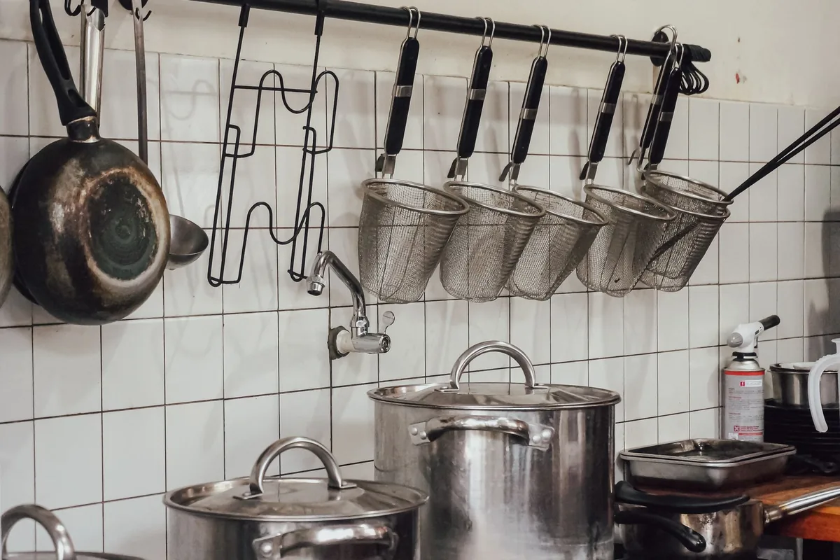 A set of pans hanging in a kitchen