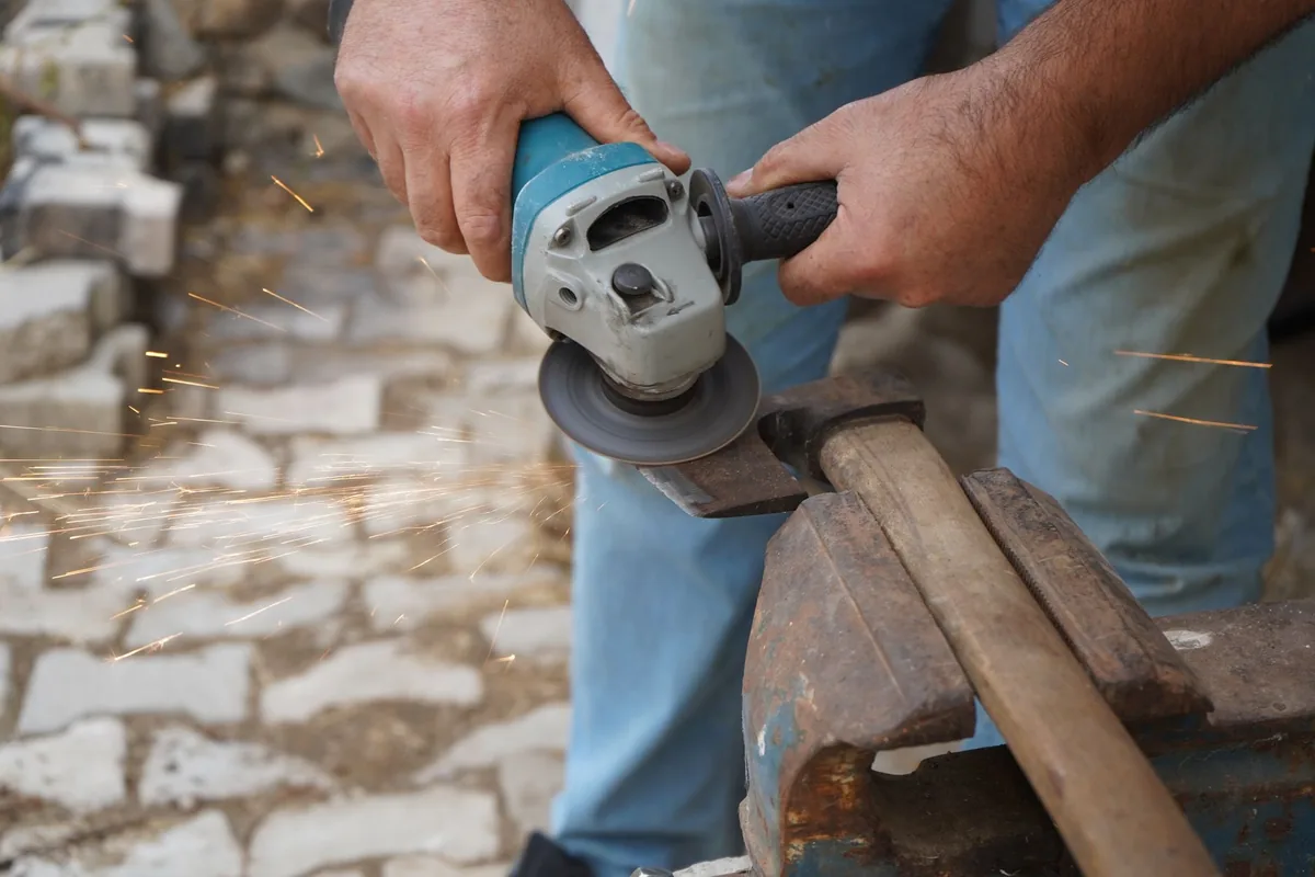 An axe head being filed