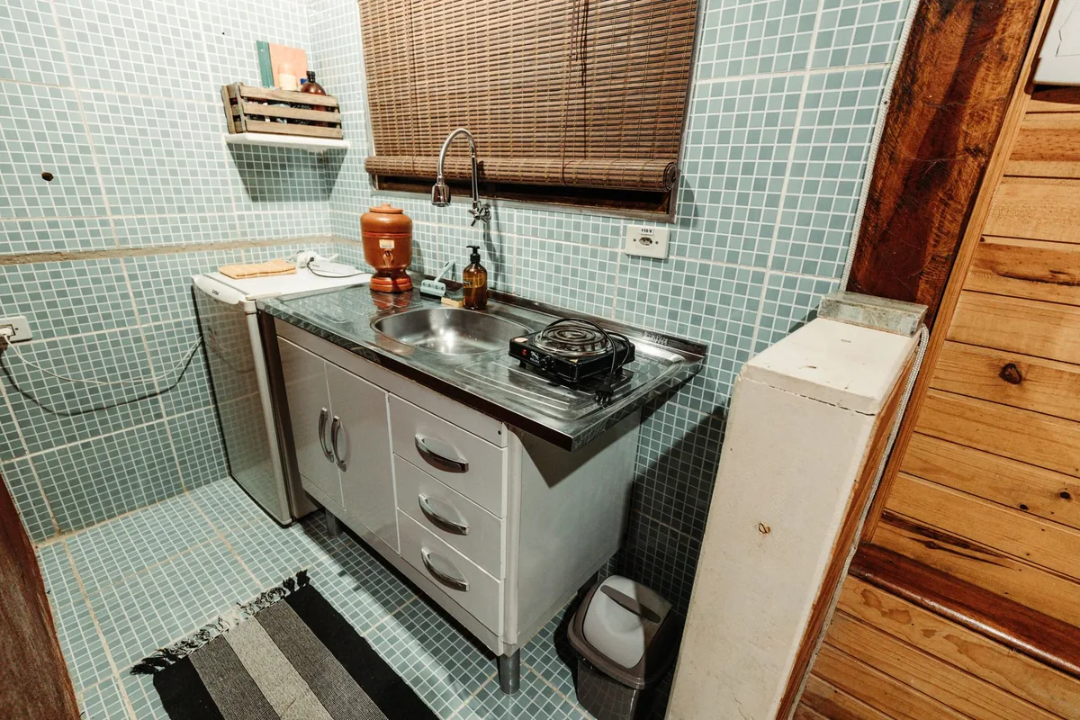 A small stylish kitchen with a metal sink