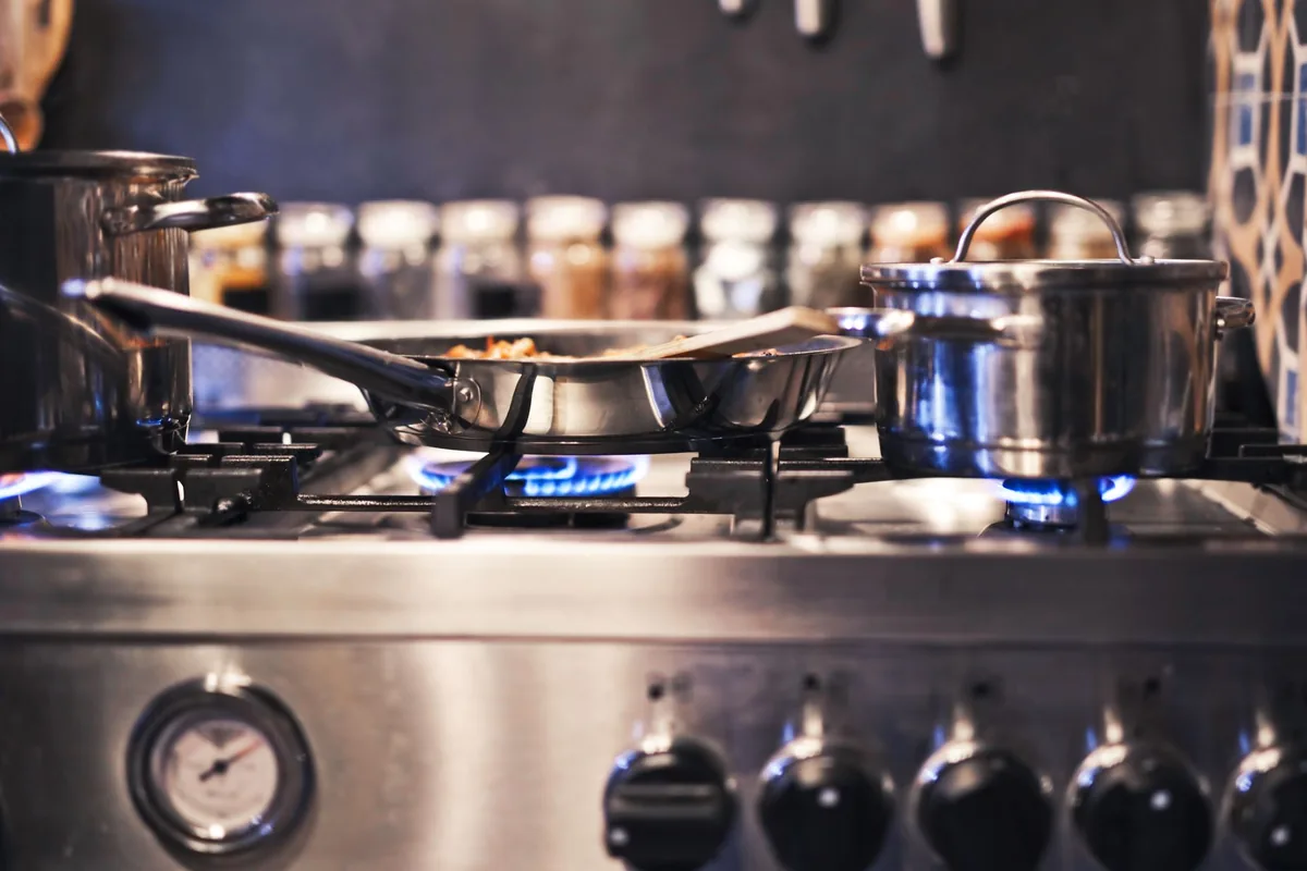A stainless pan on a gas flame