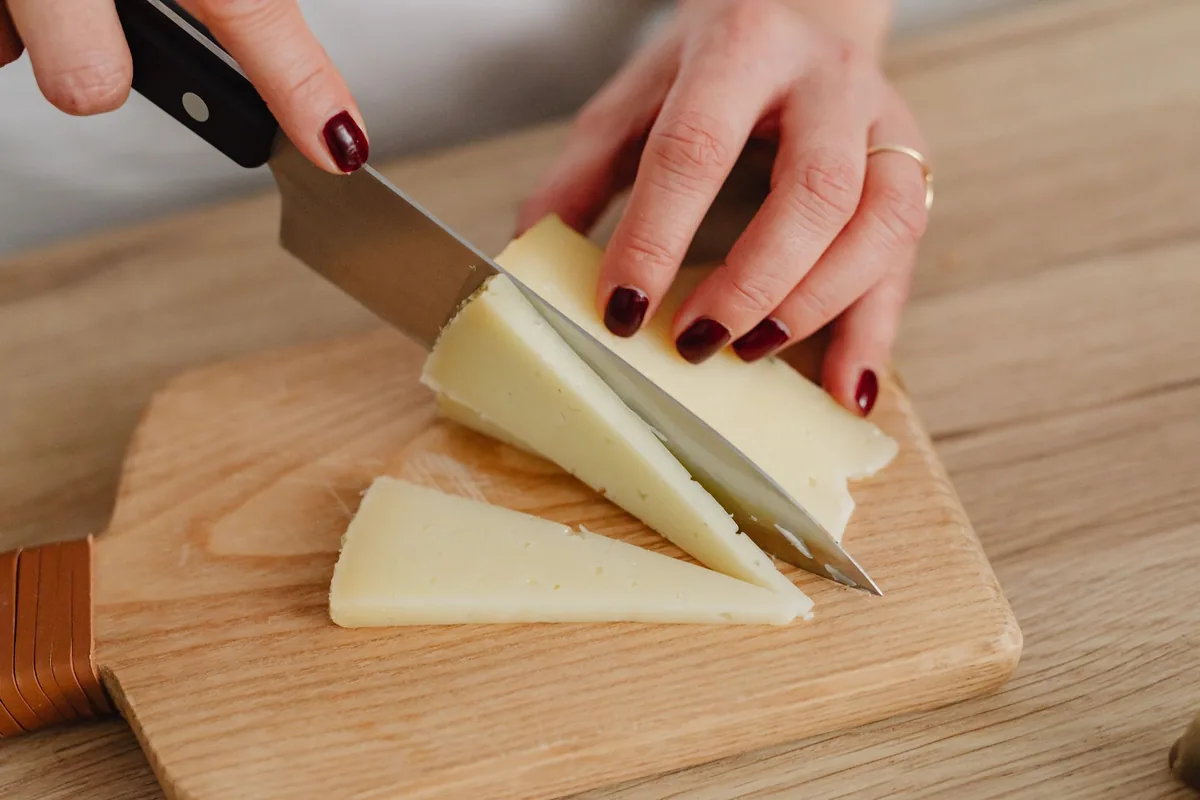 A wedge of cheese and a knife