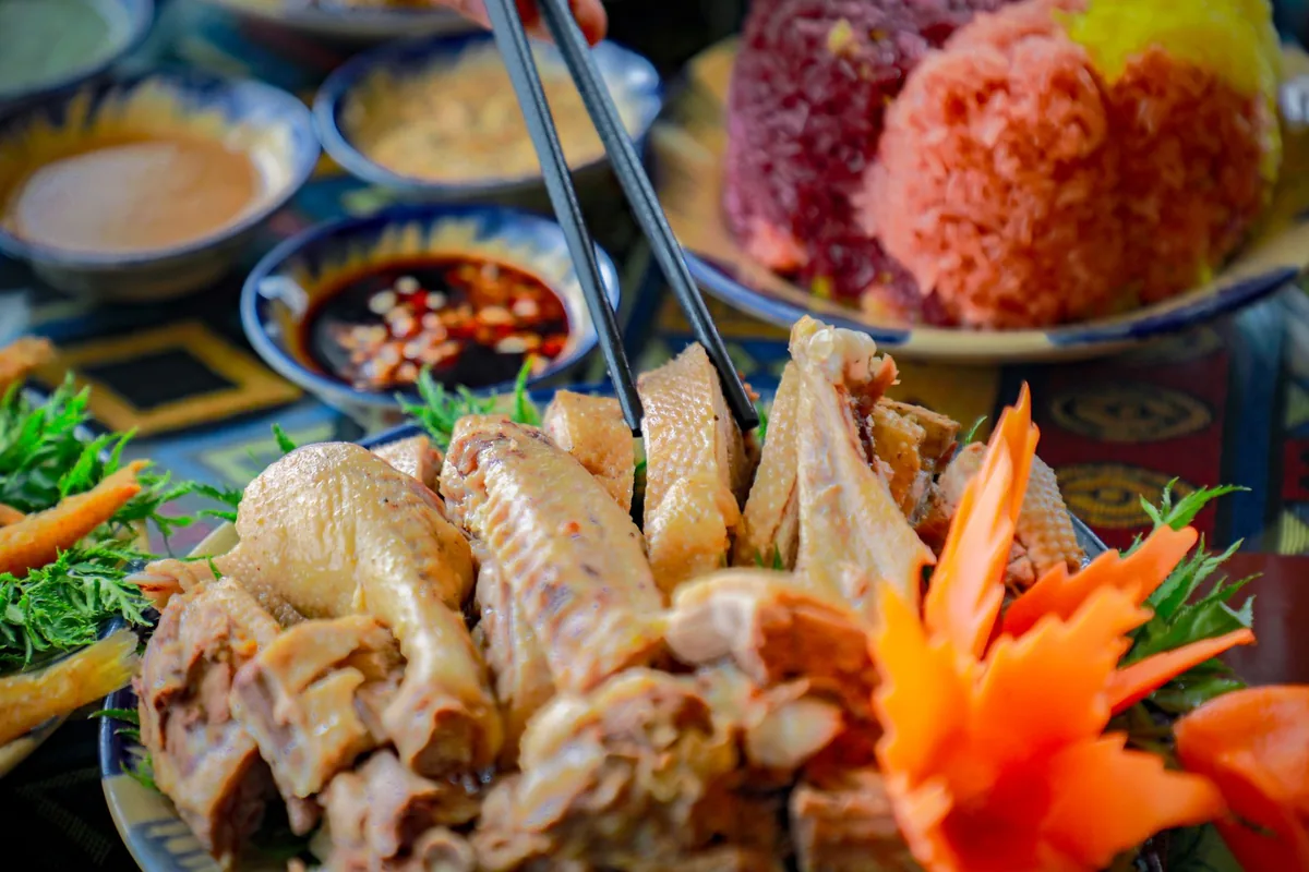 An Asian chicken dish served with rice and chopsticks