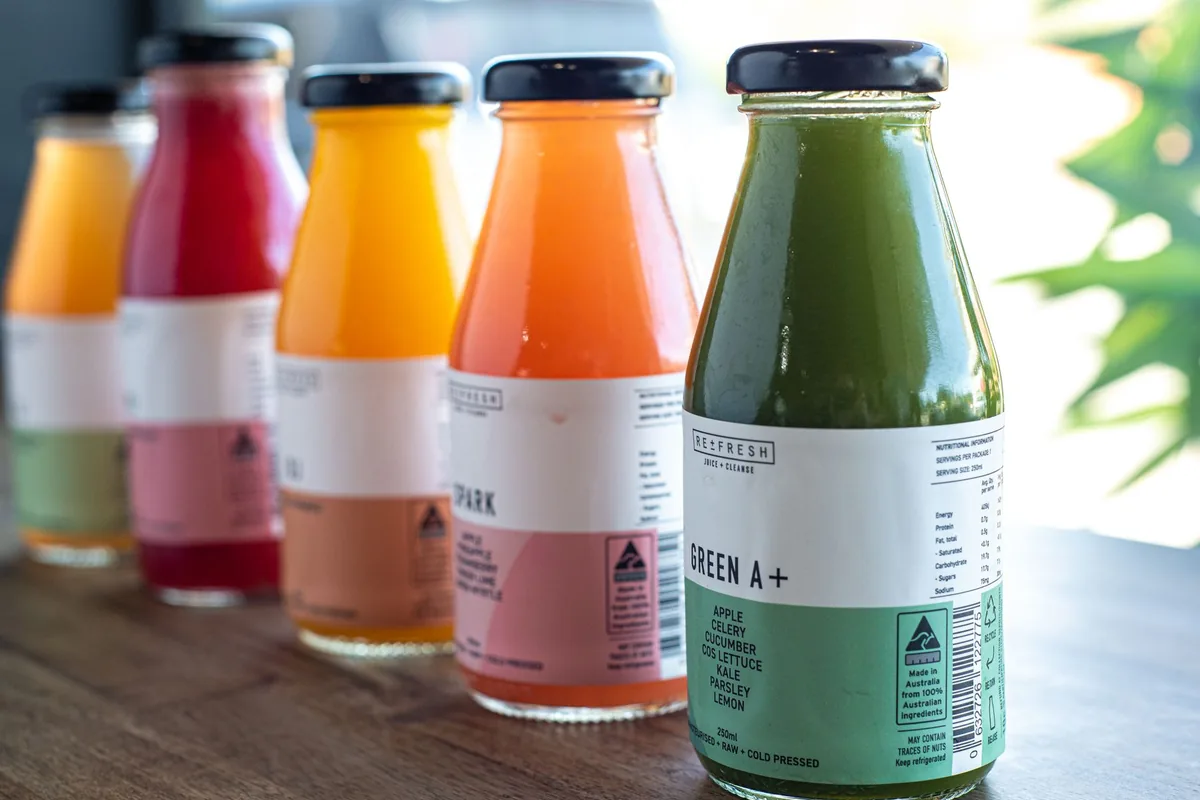 Assorted fresh bottled juices on a wooden table