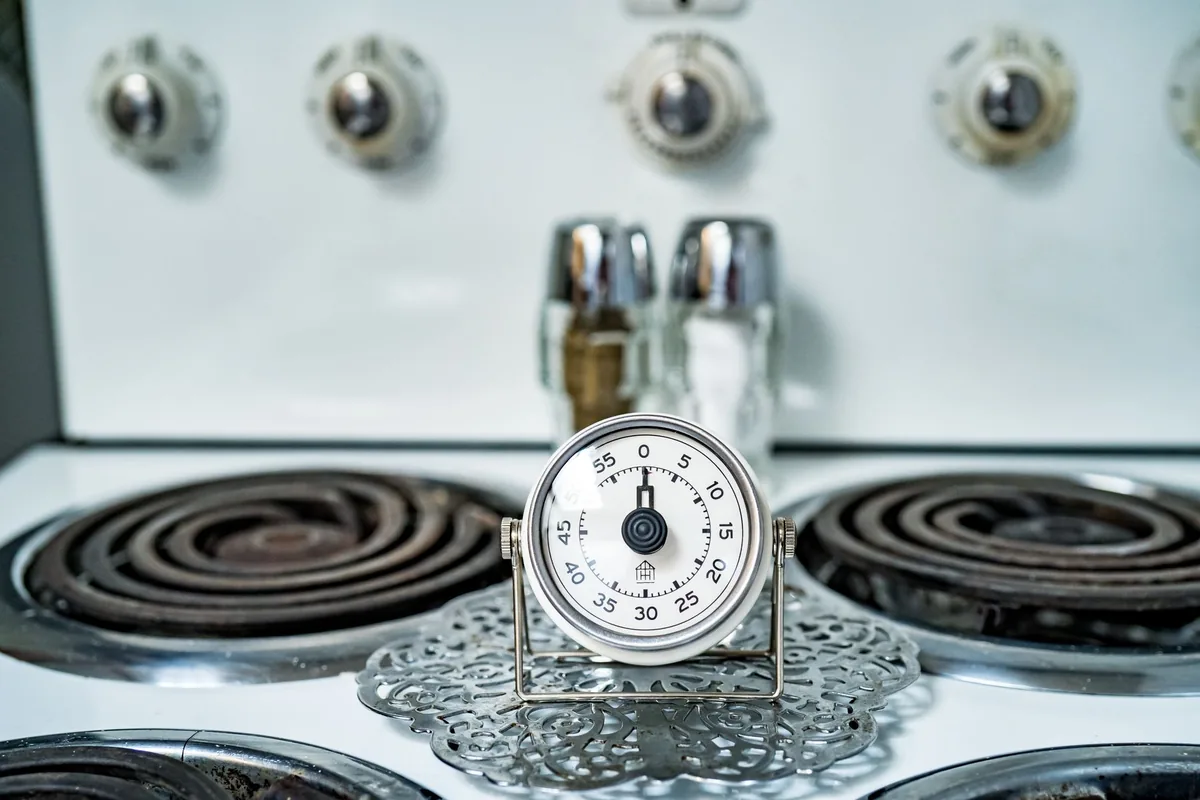Classic analog kitchen timer on a stove