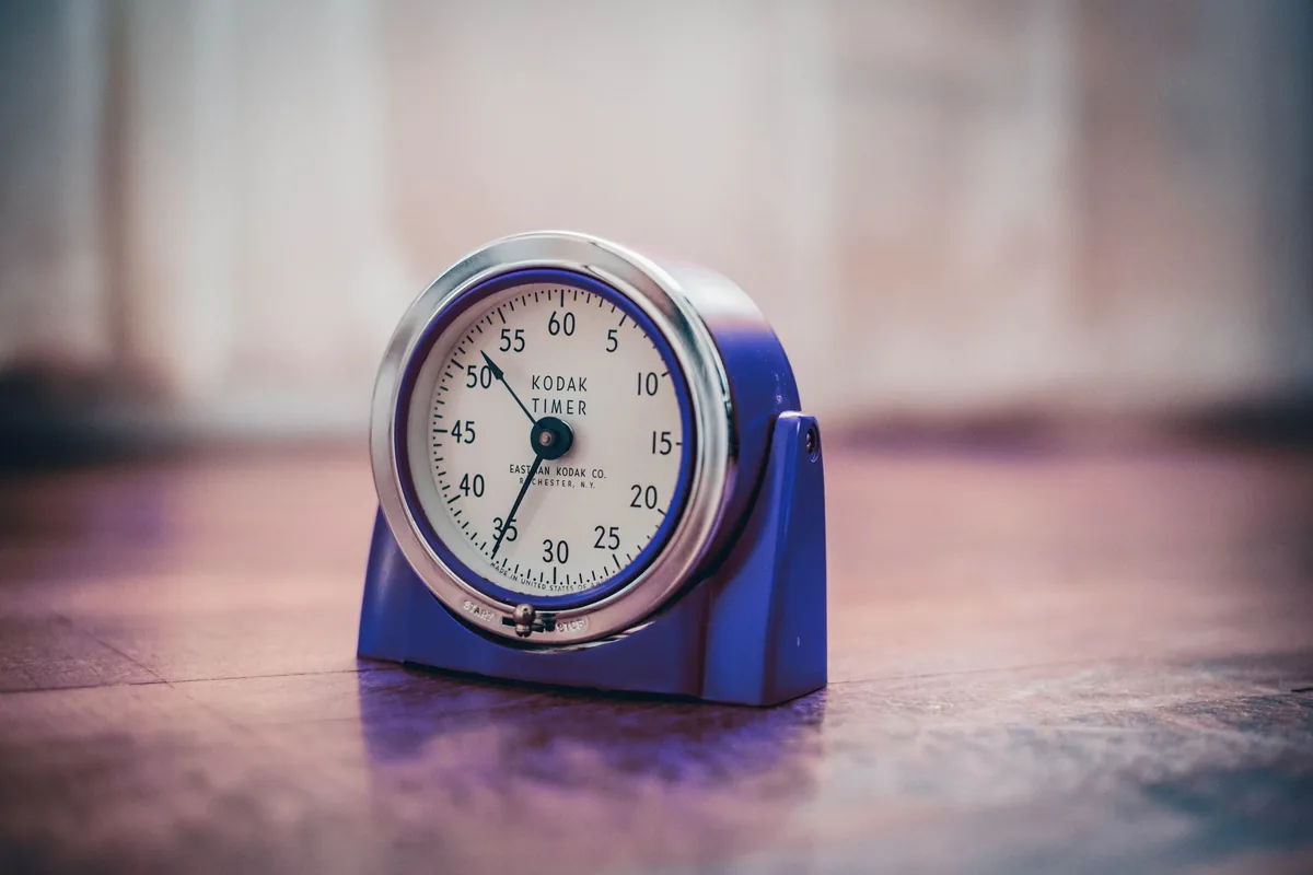Vintage timer on a wooden surface