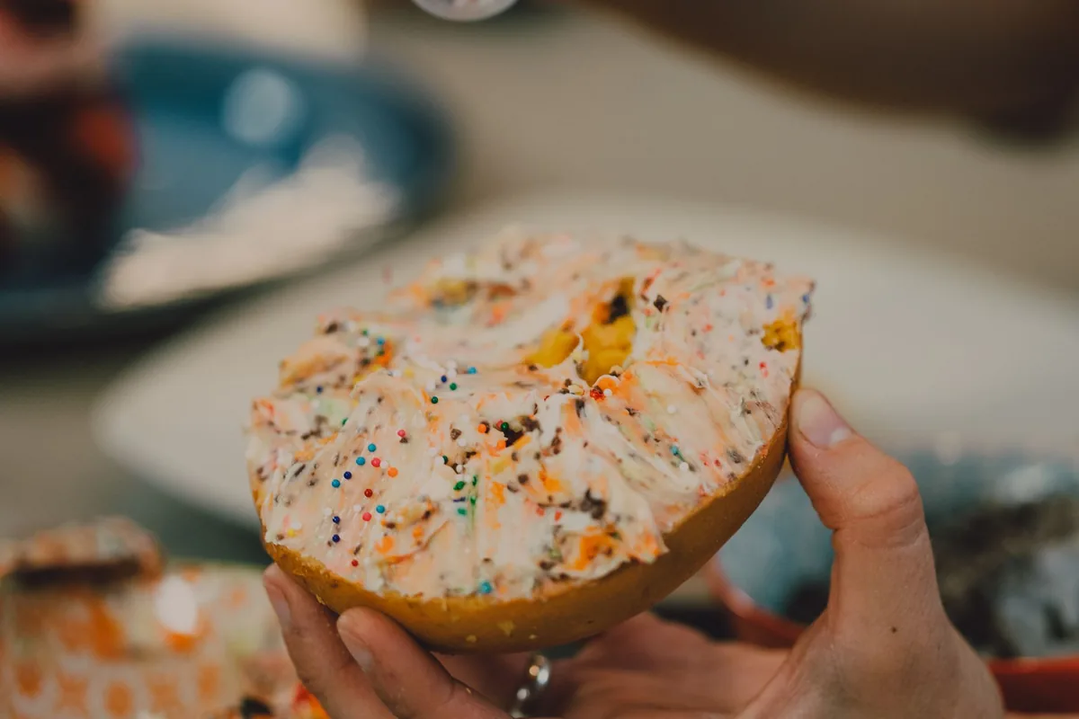 Bagel topped with colourful cream cheese