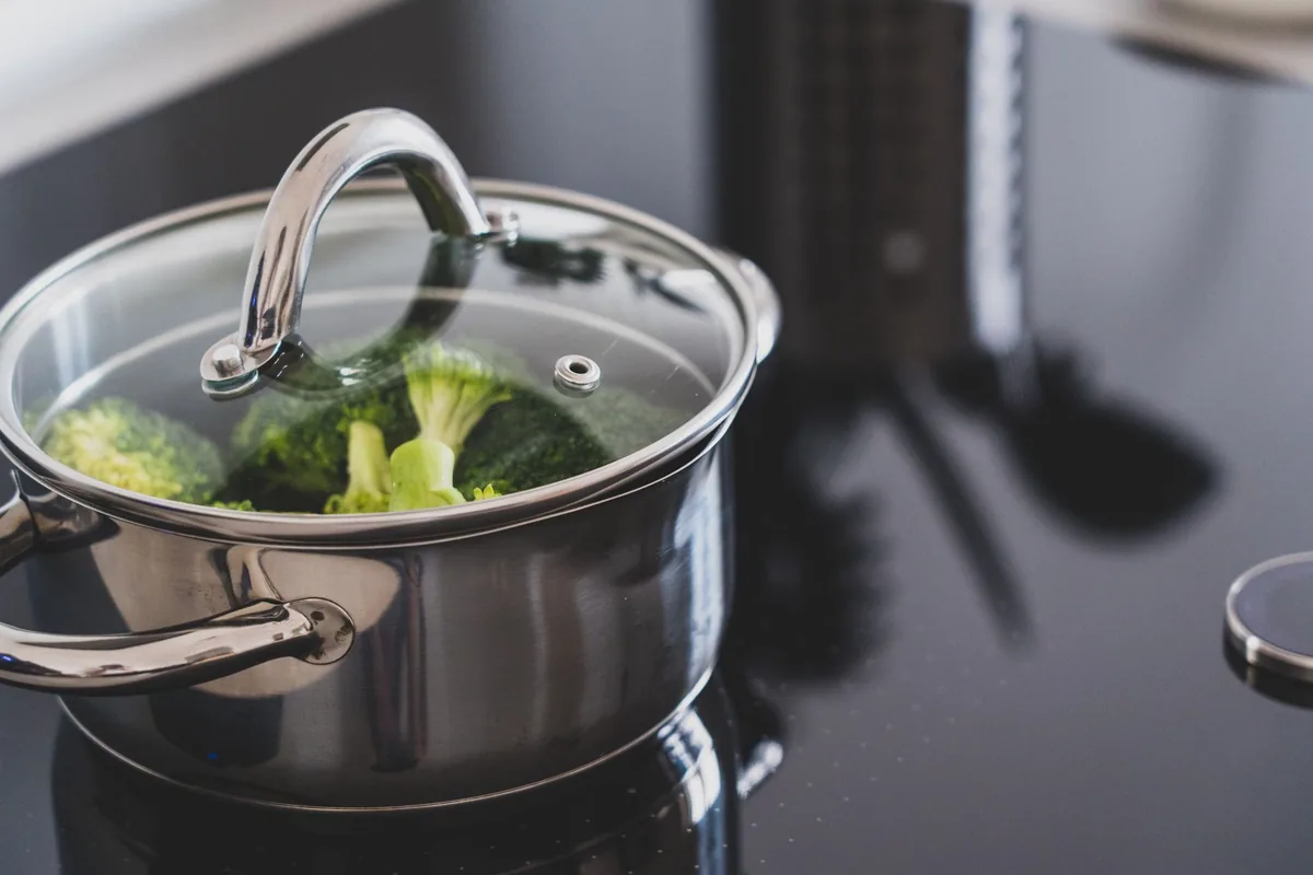 Broccoli steaming in a stainless steel pot