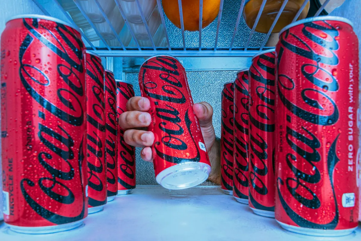 Cans stacked behind glass