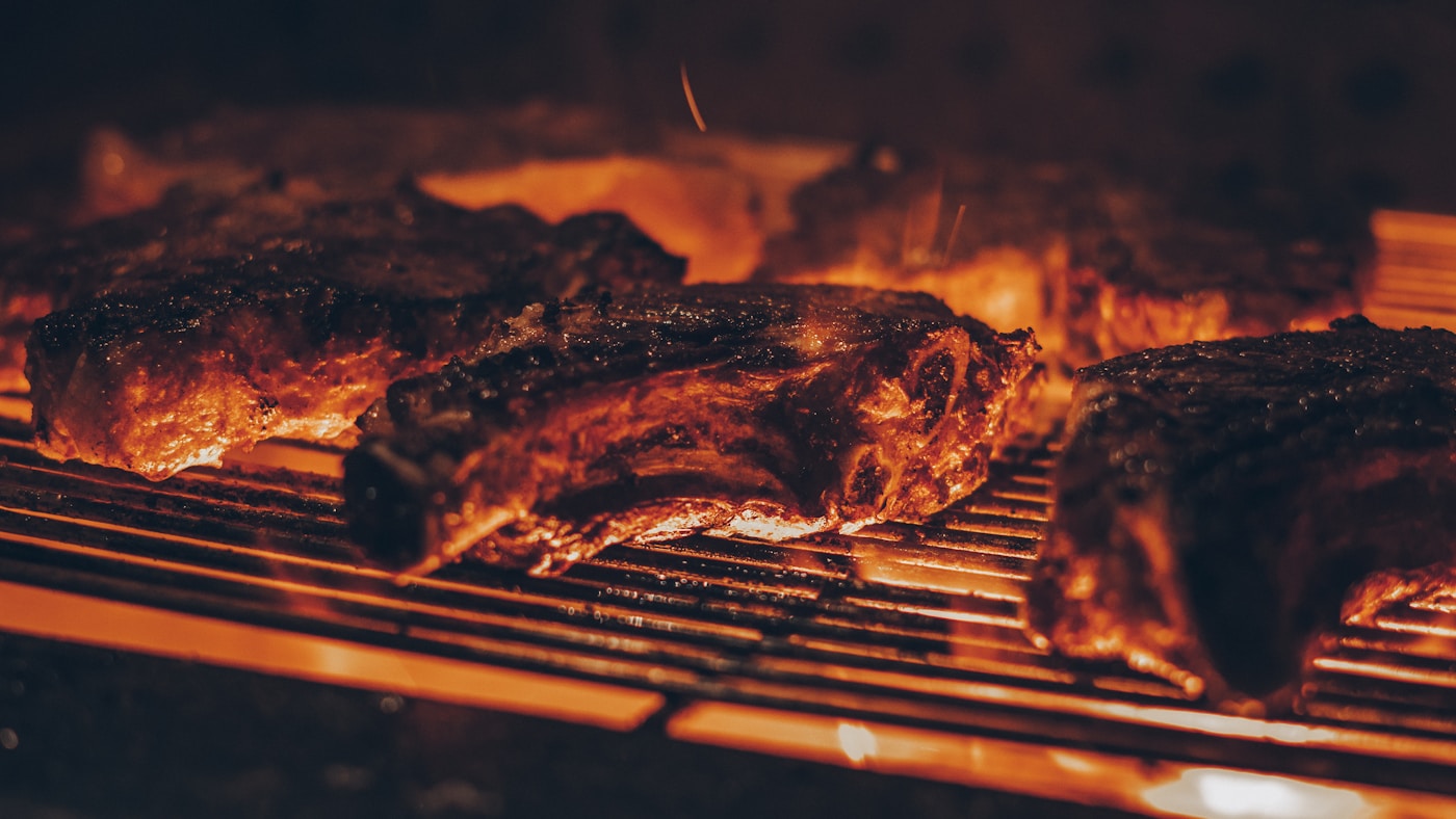 Marinated skirt steak charring on a hot grill