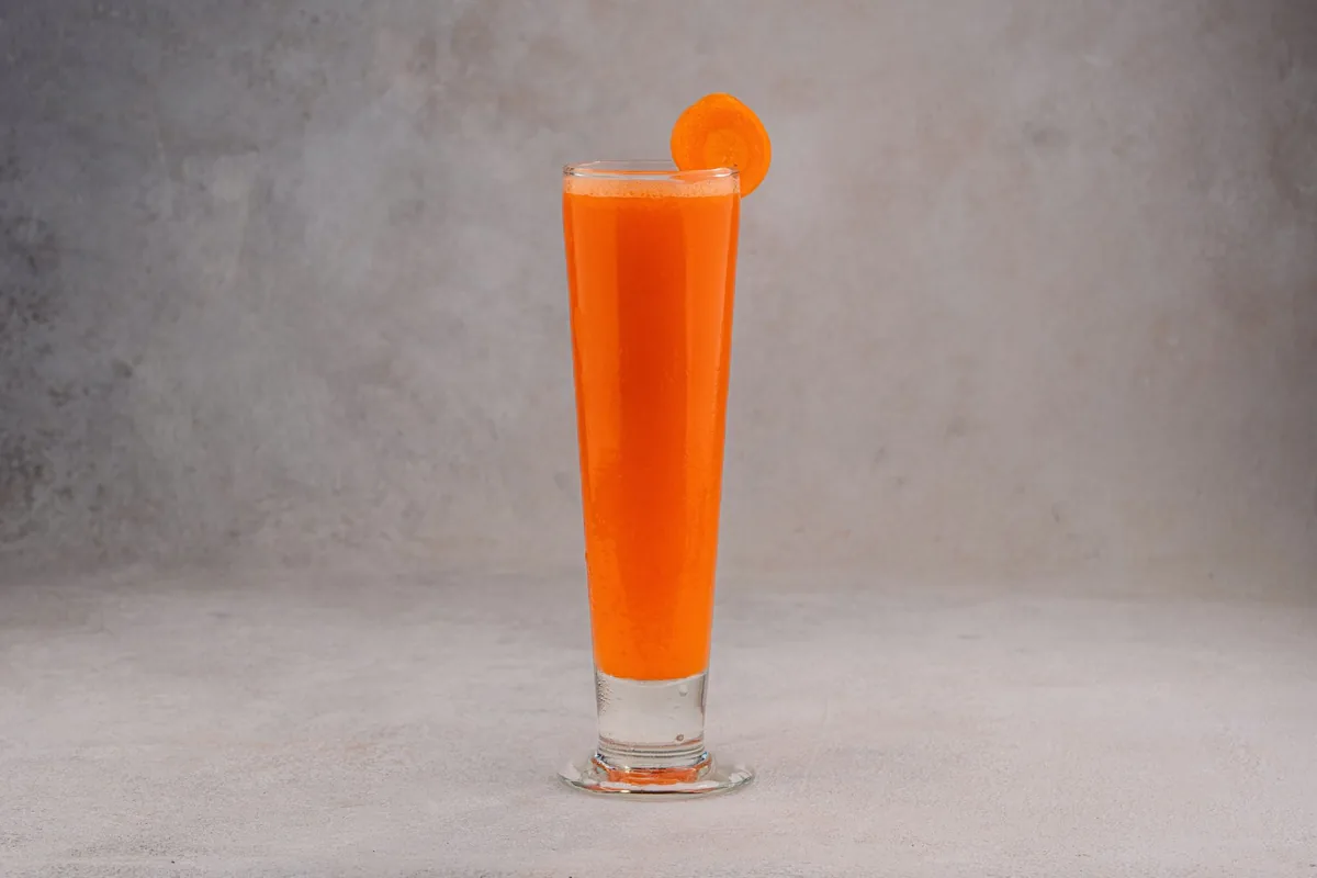 Carrot juice in a tall glass