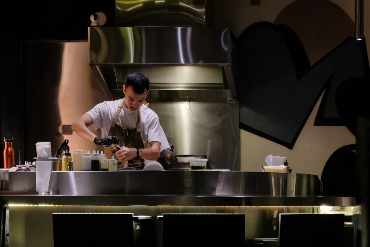 Chef working under bright kitchen task lighting