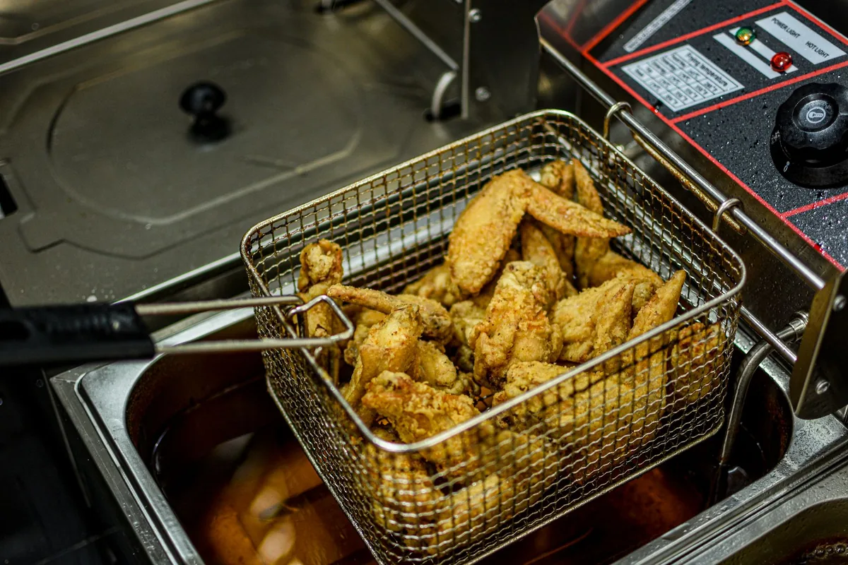 Chicken wings fried in a commercial deep fryer