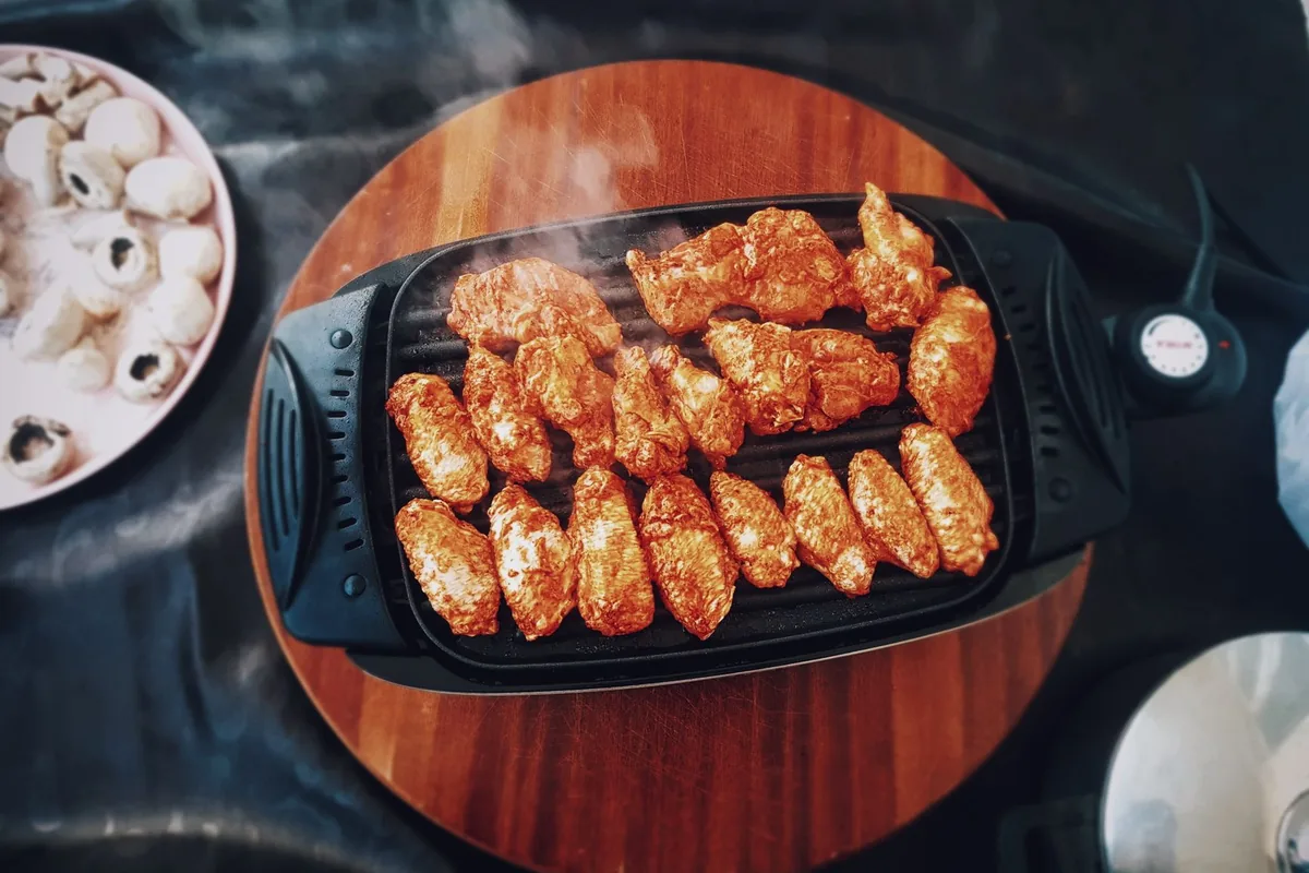 Chicken wings grilling on an electric grill