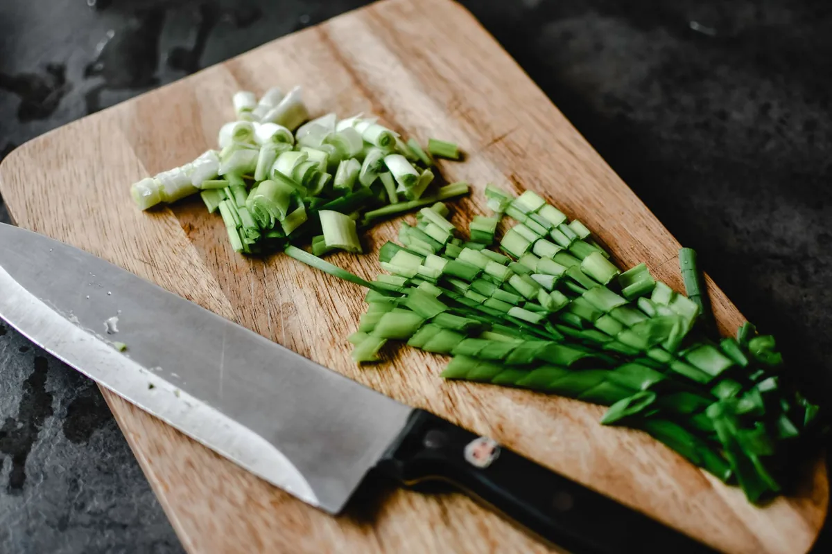 Chopped vegetables beside a blender