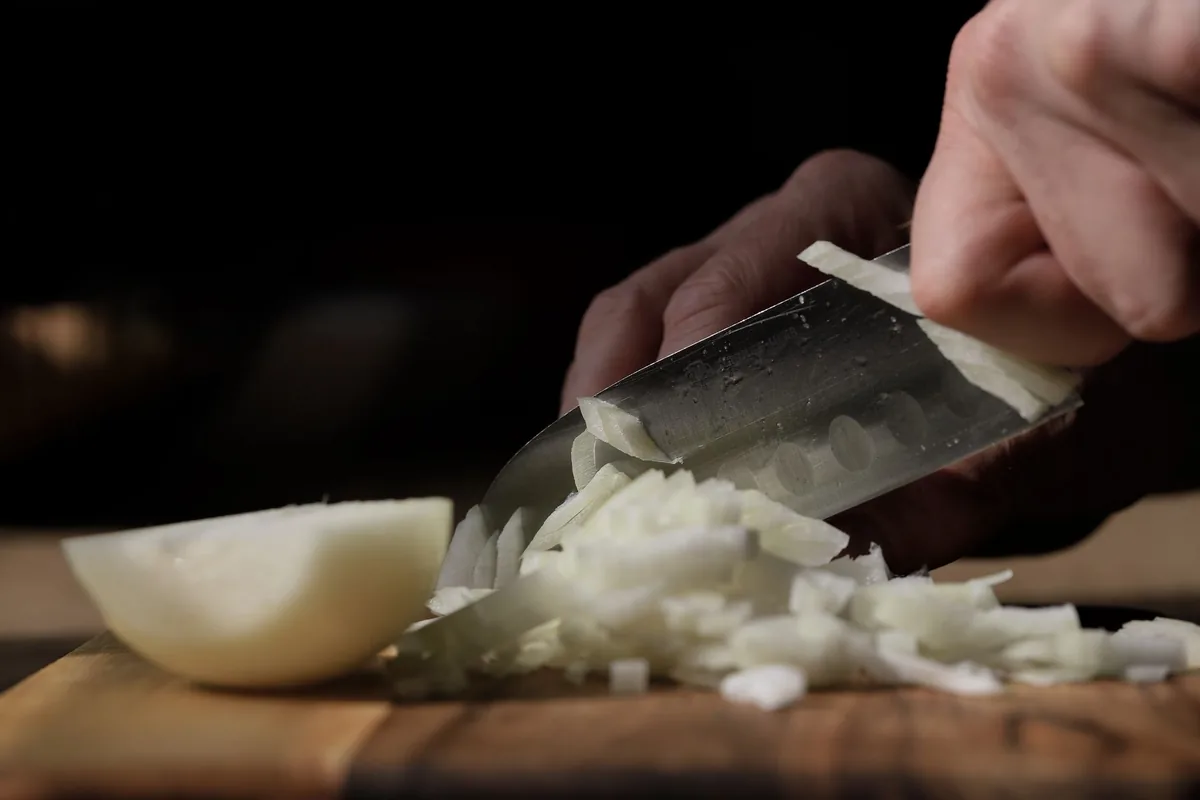 Chopping onions on a board