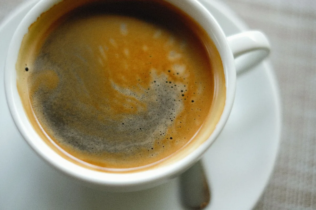 Coffee crema and sediment in a cup
