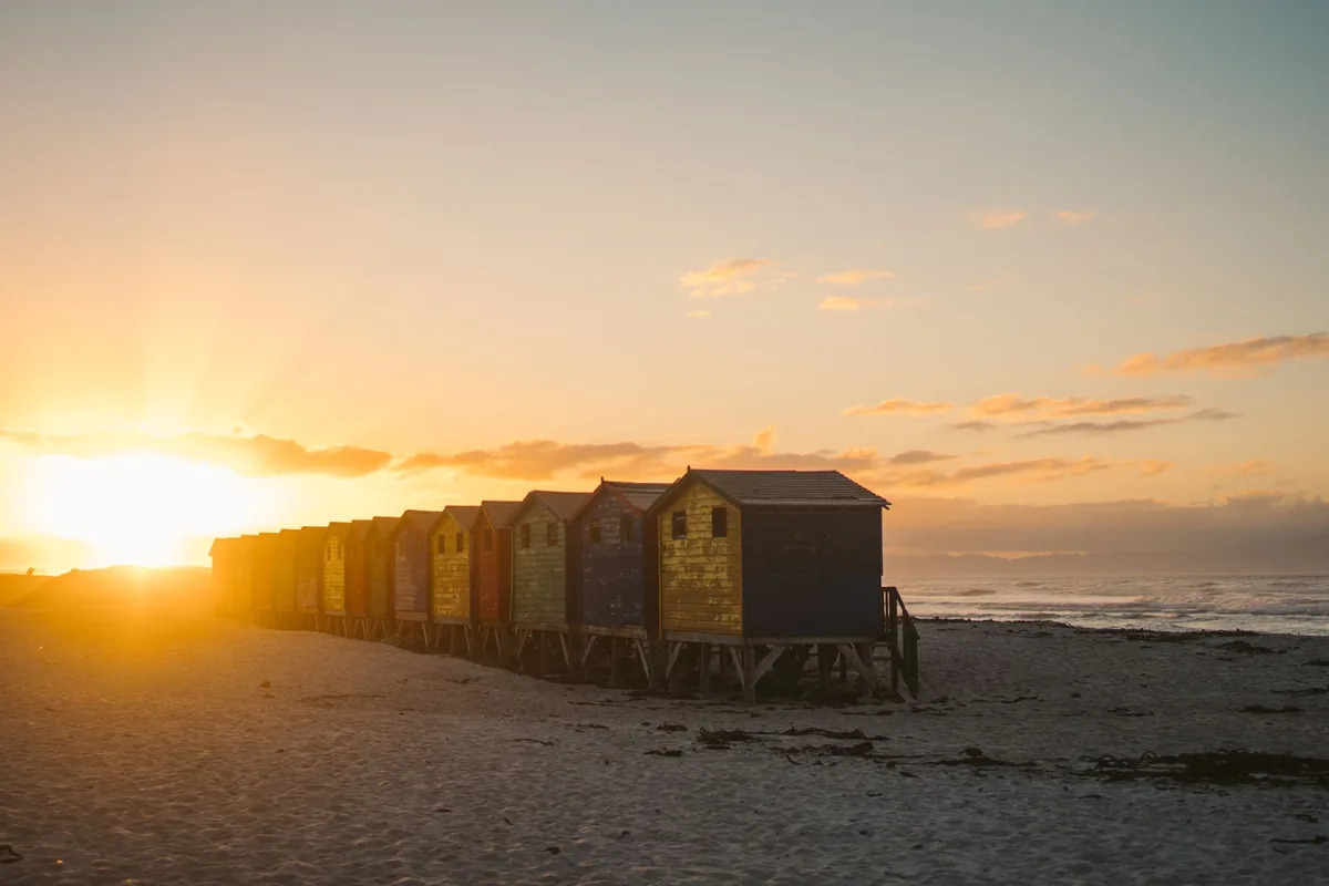 Colourful beach huts at sunrise