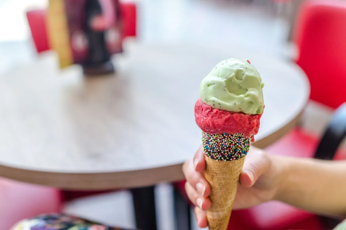 Colourful ice cream cone topped with mint