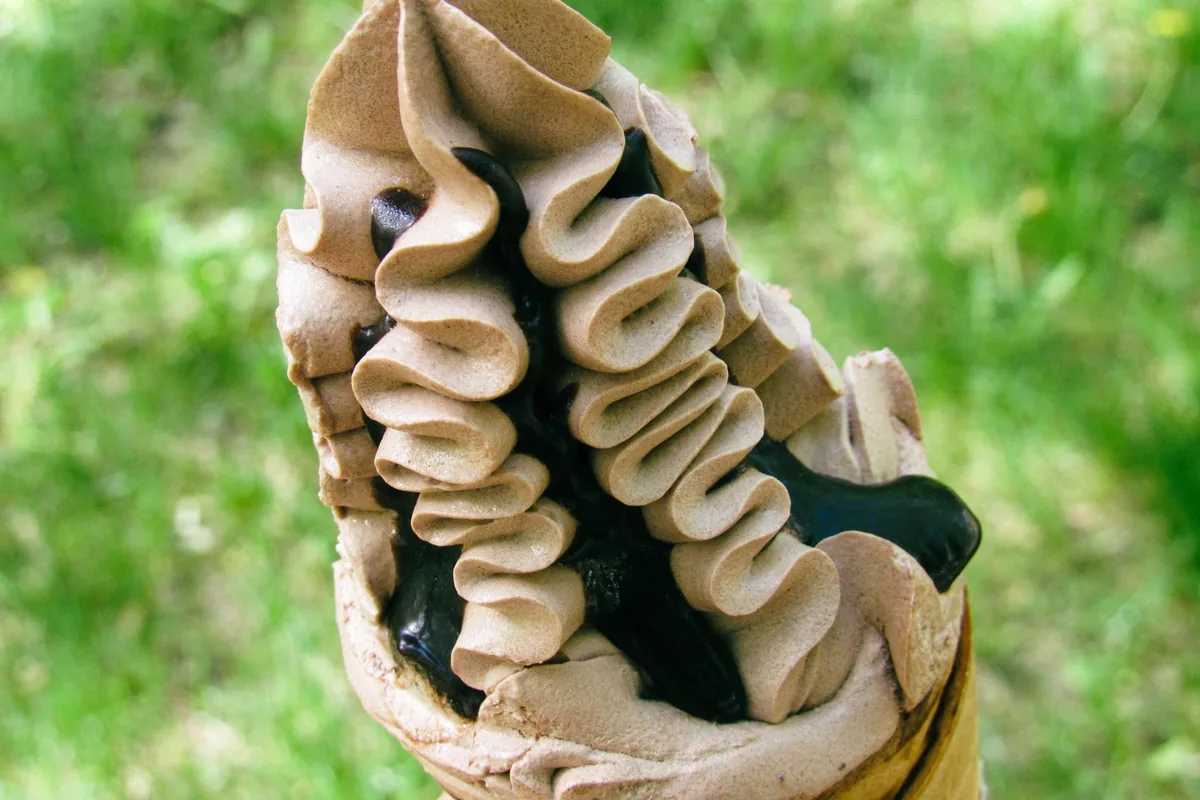 Chocolate ice cream cone with creamy swirls