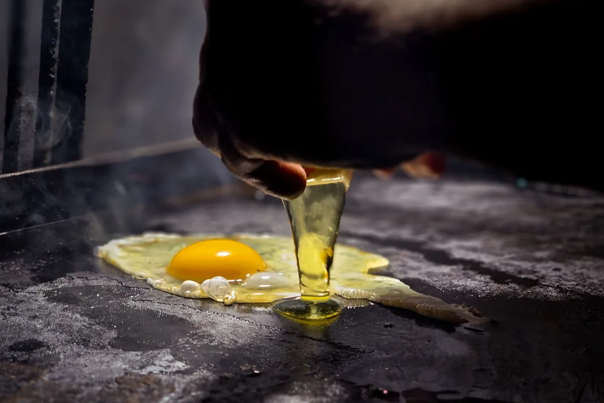 Cracking an egg onto a hot griddle