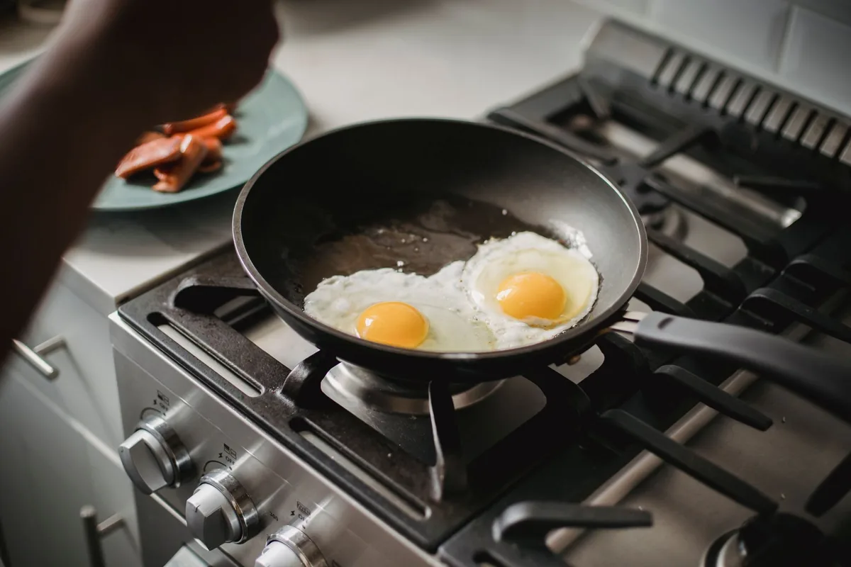 Eggs frying in a heavy pan