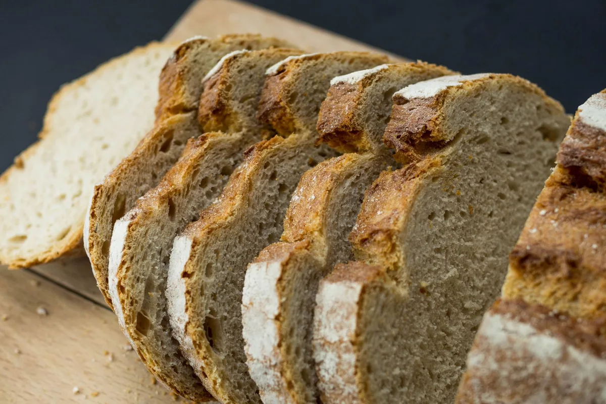 Freshly sliced wheat bread on a wooden board