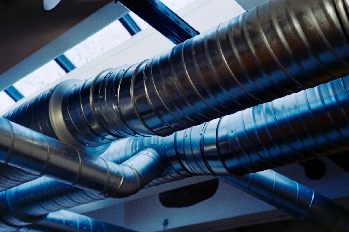 Flexible ducting running through a cabinet space