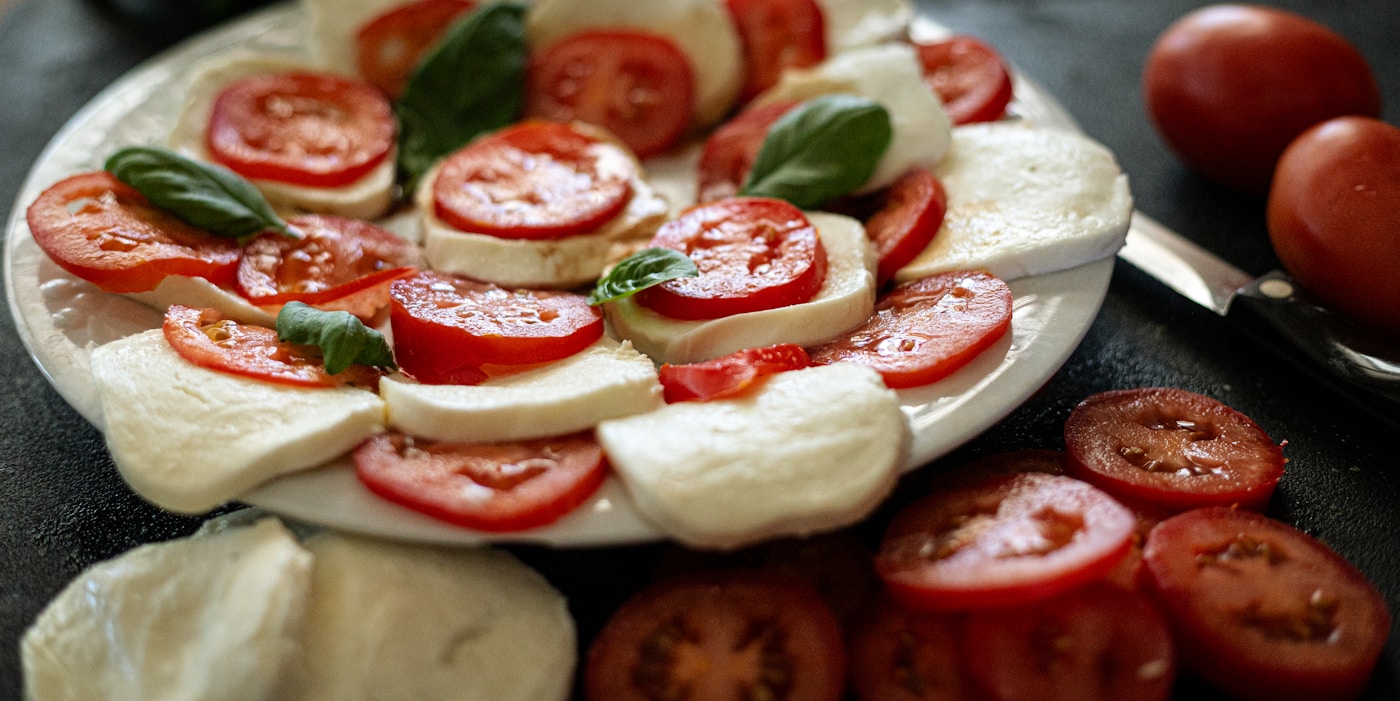 Fresh mozzarella slices with tomato and basil, caprese style