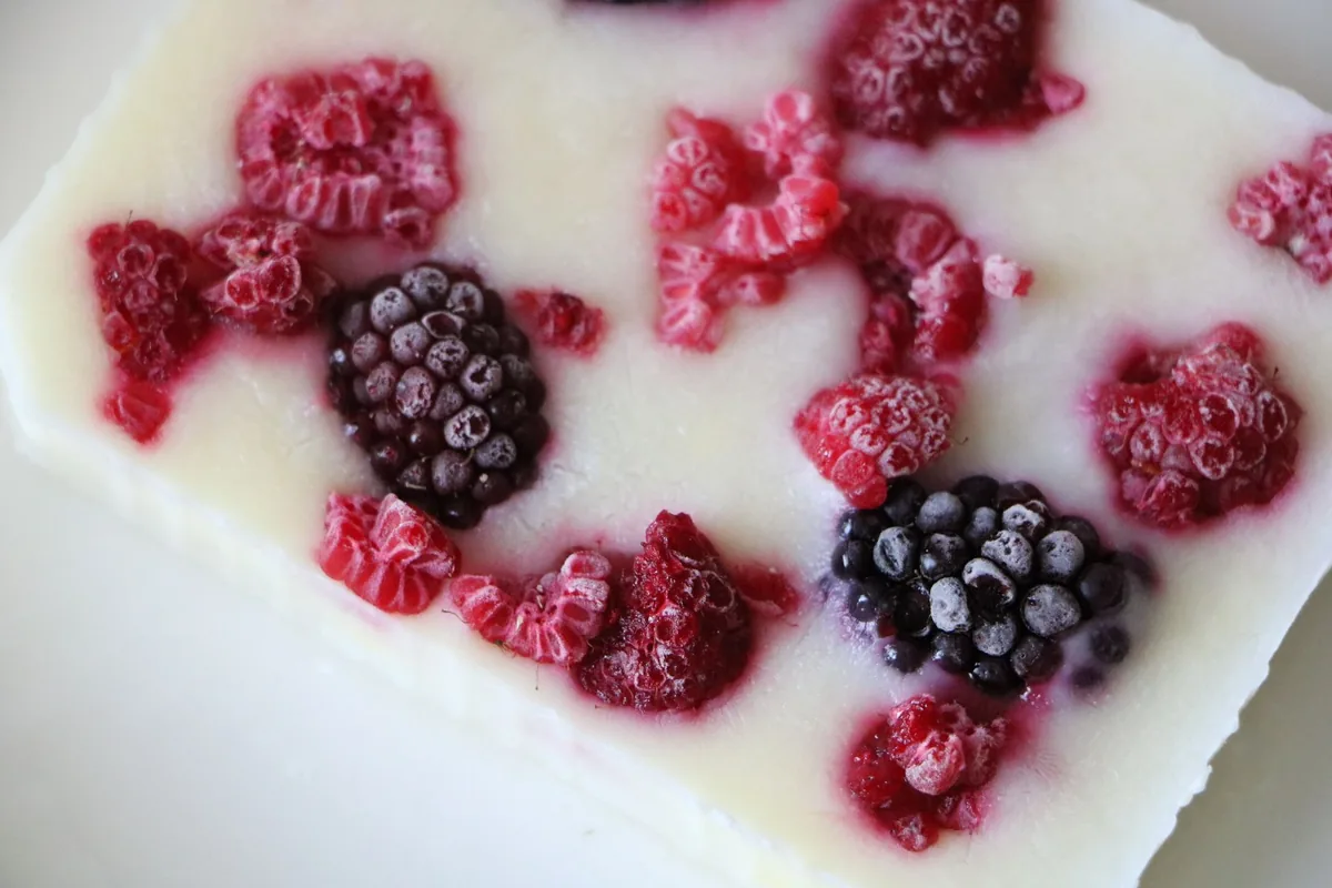 Frozen berries on a creamy yogurt bar