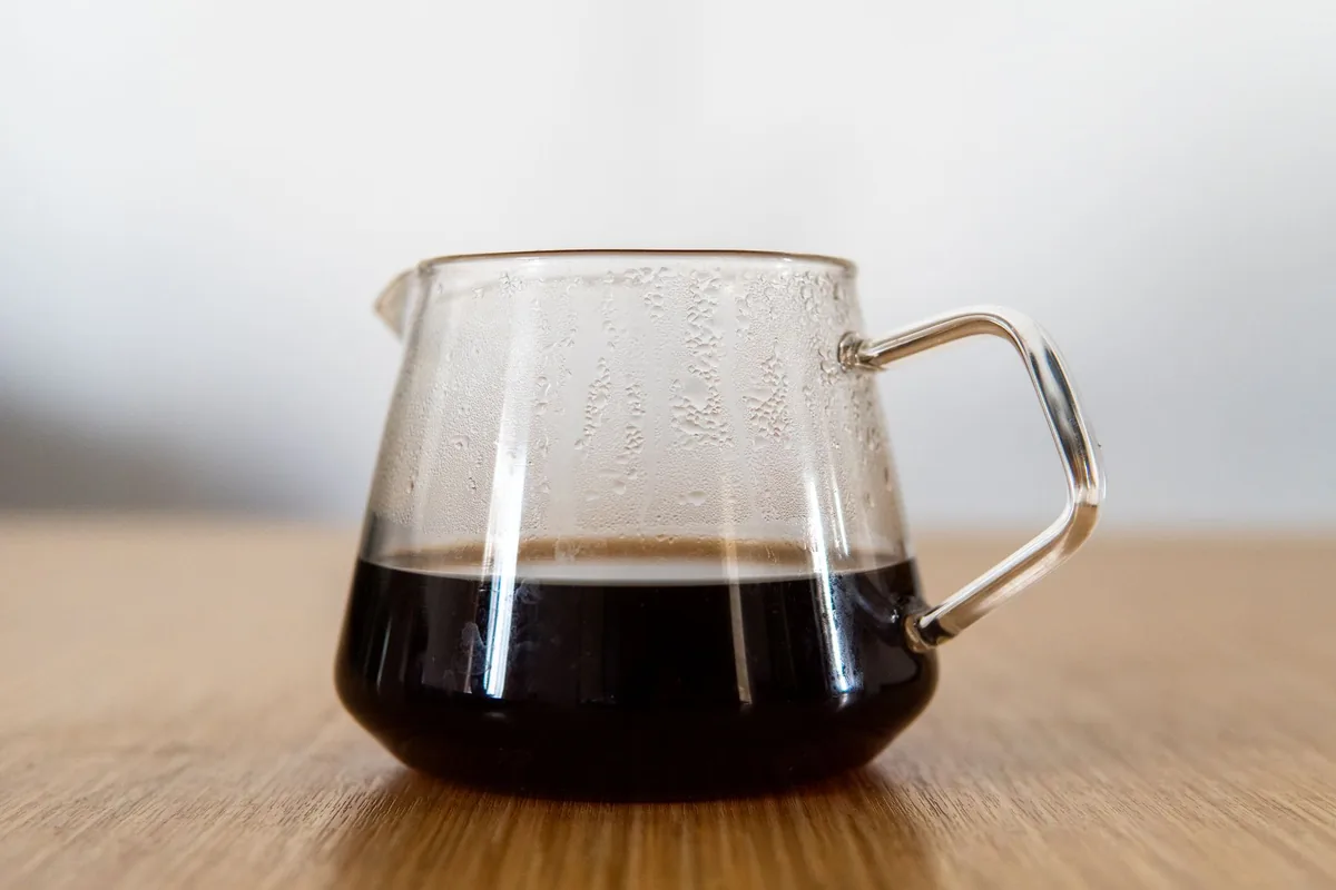 A glass carafe of freshly brewed black coffee