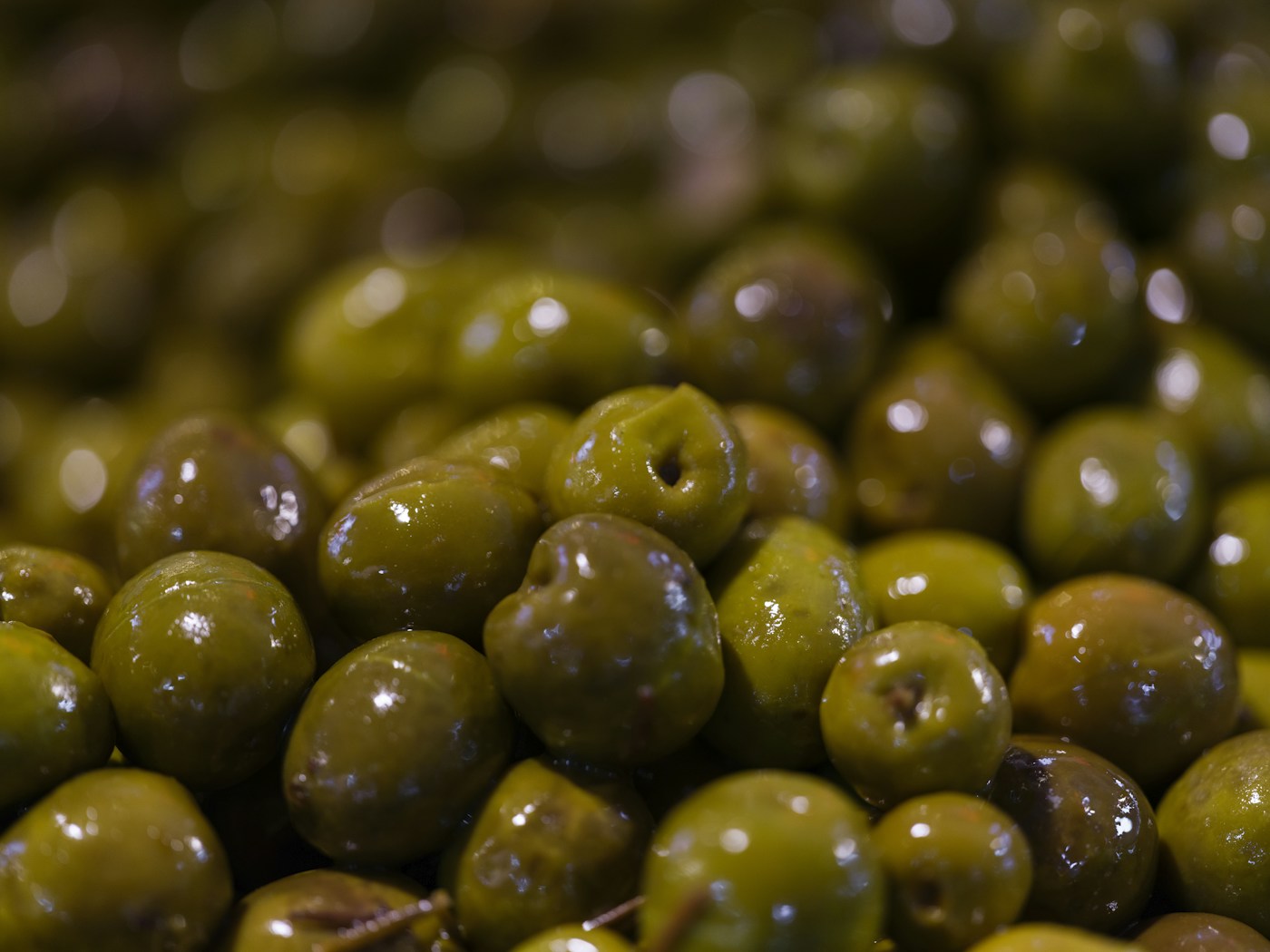 Close-up pile of glossy green olives