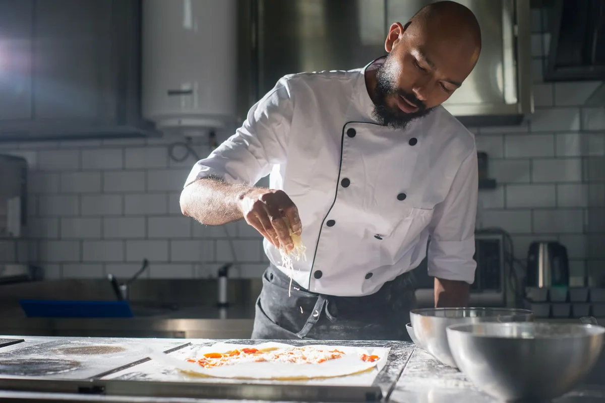 Hands preparing pizza