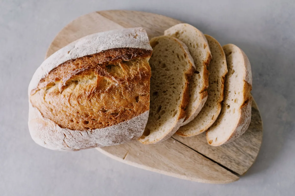 Freshly sliced artisan bread on a rustic board