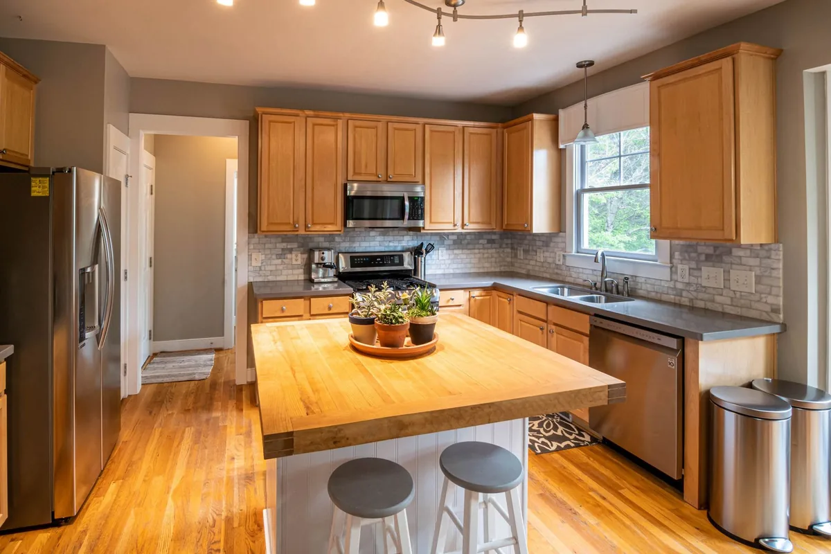 Modern kitchen with wooden cabinets, island and stainless steel appliances