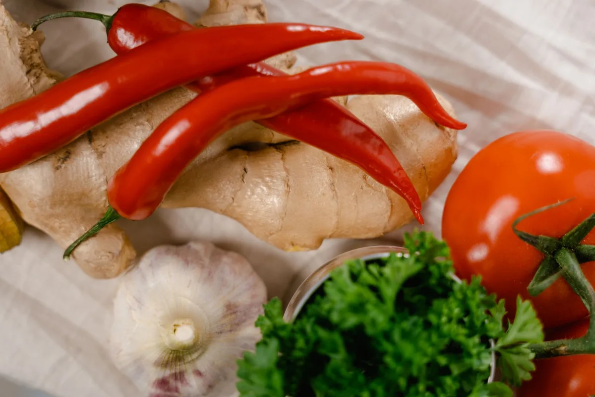 Fresh chilli peppers, ginger and aromatics on a board